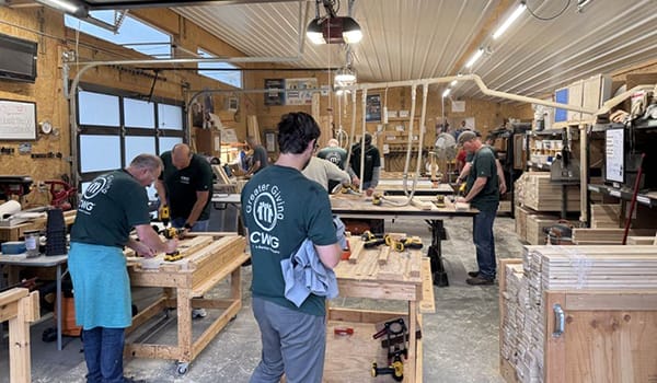 CWG Risk Services team volunteering in a woodshop
