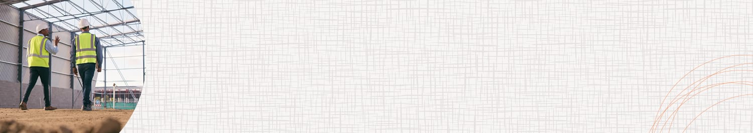 Two men walking through a construction site