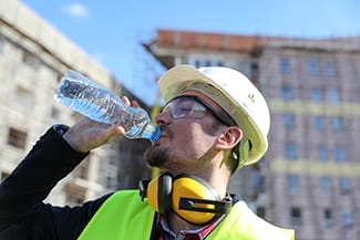 construction worker drinking from water bottle